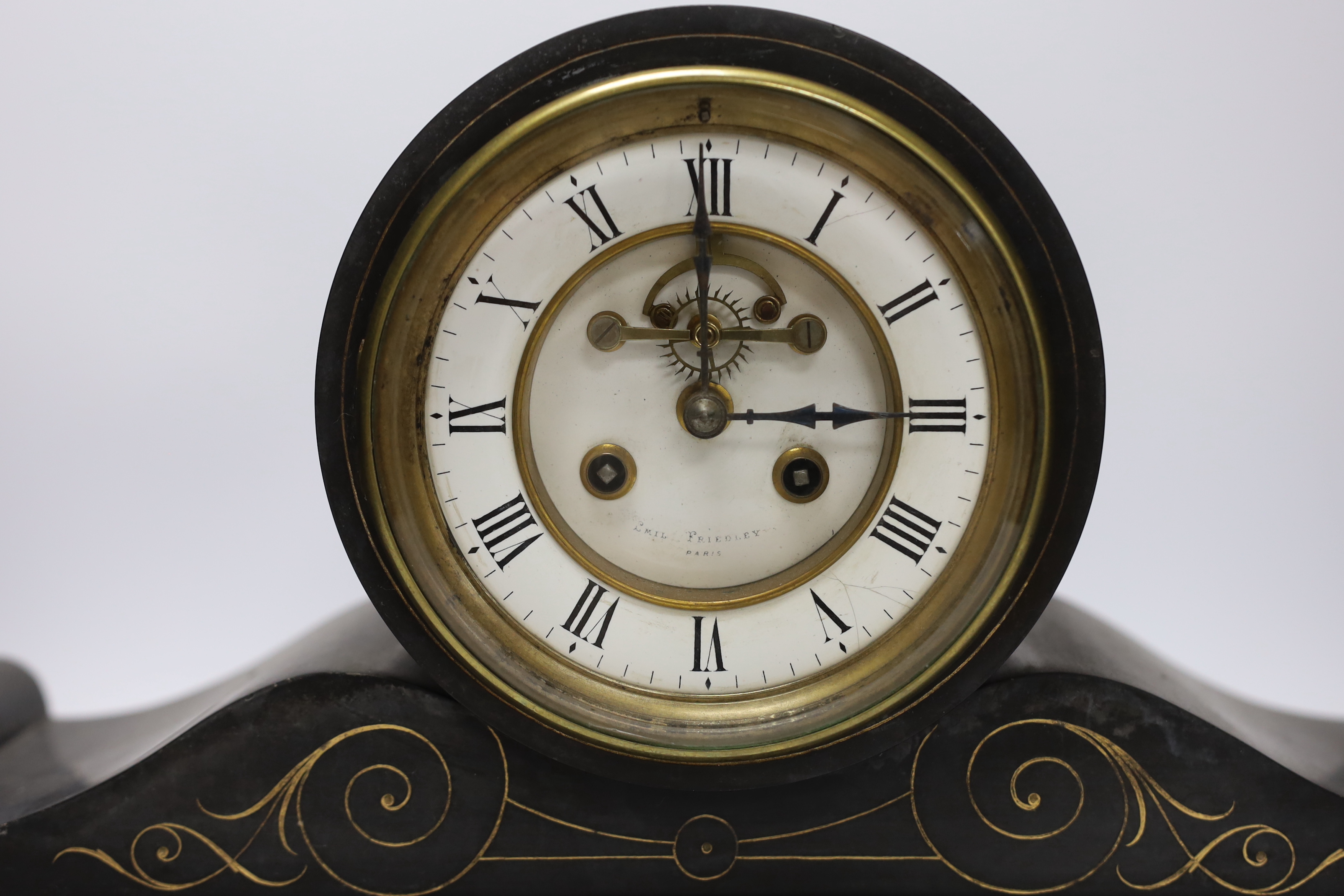 A 19th century French polished black slate mantel clock, 50cm wide